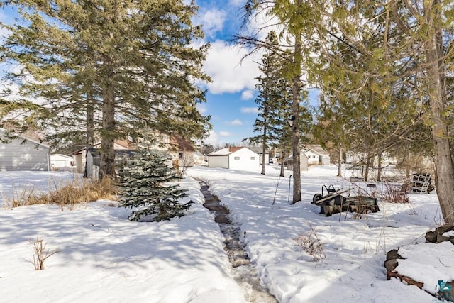 snowy yard featuring a residential view