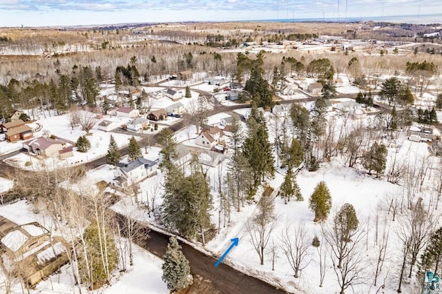 snowy aerial view with a residential view