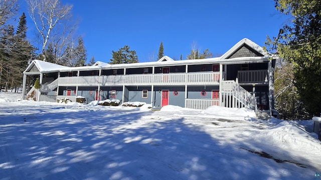 multi unit property featuring a porch and stairs