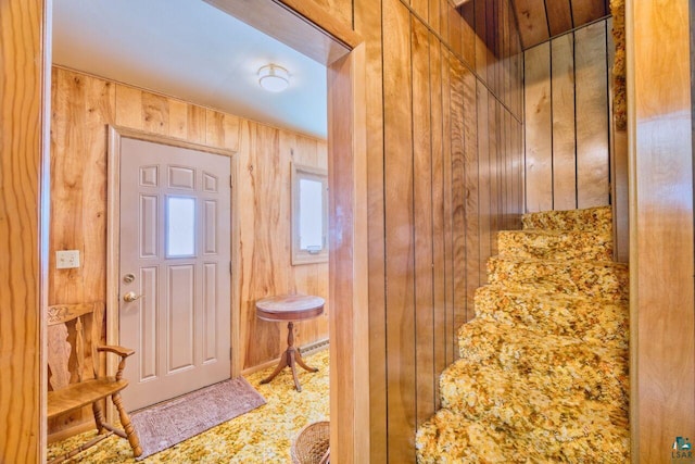 foyer with wood walls