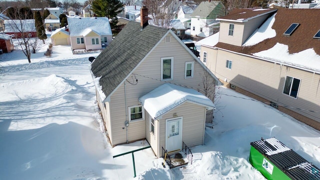 snowy aerial view with a residential view