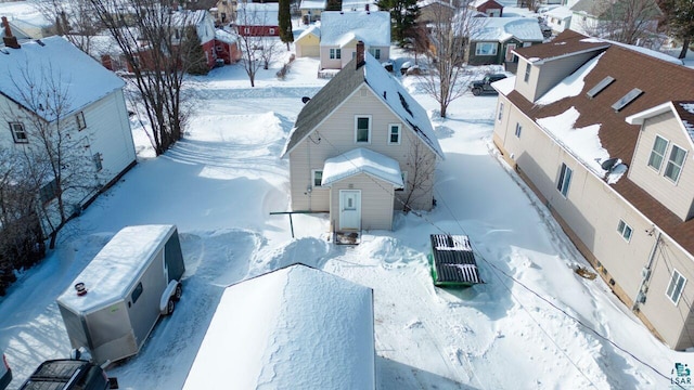 snowy aerial view featuring a residential view