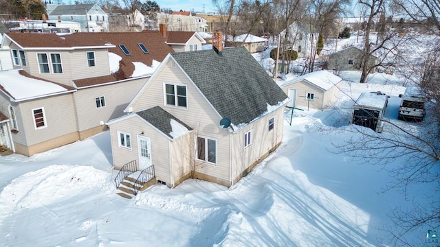 snowy aerial view with a residential view