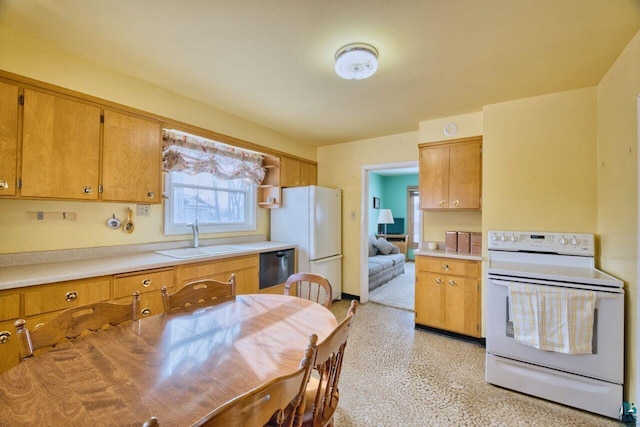 kitchen with brown cabinets, white appliances, light countertops, and a sink