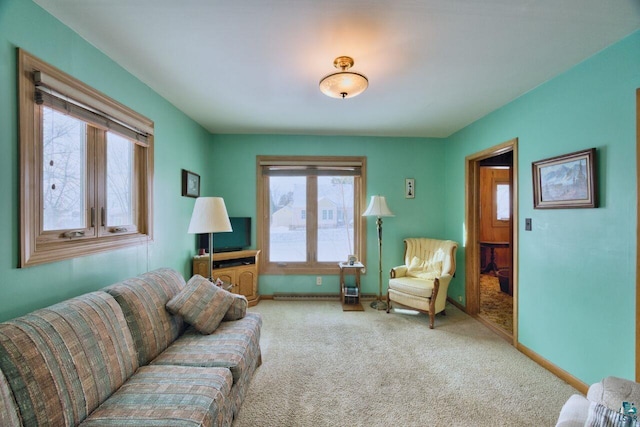 living room featuring carpet and baseboards