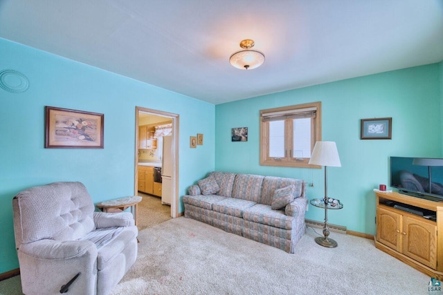 living area with baseboards, light carpet, and baseboard heating