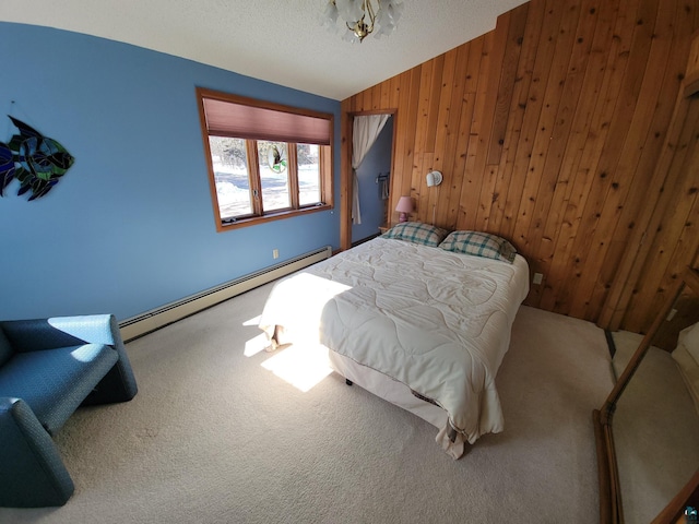 bedroom with carpet floors, a baseboard radiator, lofted ceiling, wooden walls, and a textured ceiling