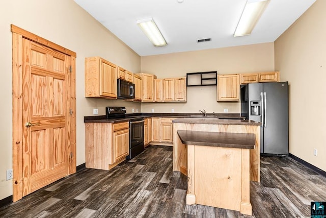 kitchen featuring light brown cabinets, a sink, a center island, black appliances, and dark countertops