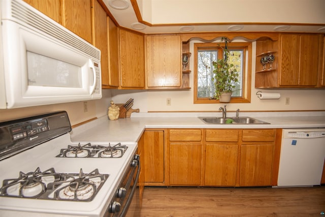 kitchen featuring light countertops, white appliances, open shelves, and a sink