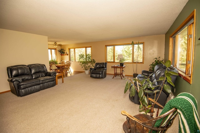 carpeted living room with baseboards