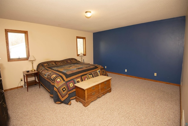 bedroom with light carpet and baseboards