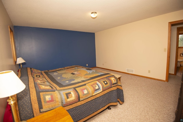 carpeted bedroom featuring visible vents and baseboards