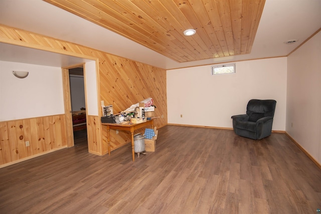 interior space with dark wood-style floors, visible vents, wood walls, and wood ceiling