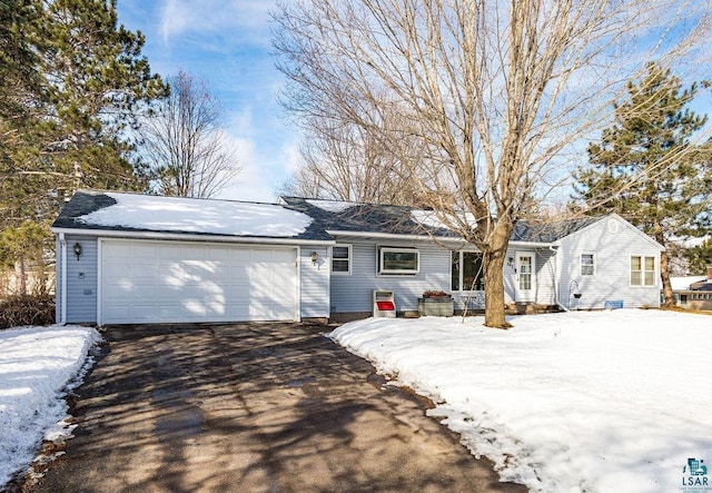 ranch-style house featuring an attached garage and driveway