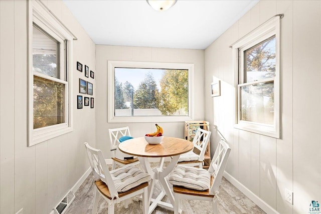 dining room with baseboards, visible vents, and a wealth of natural light