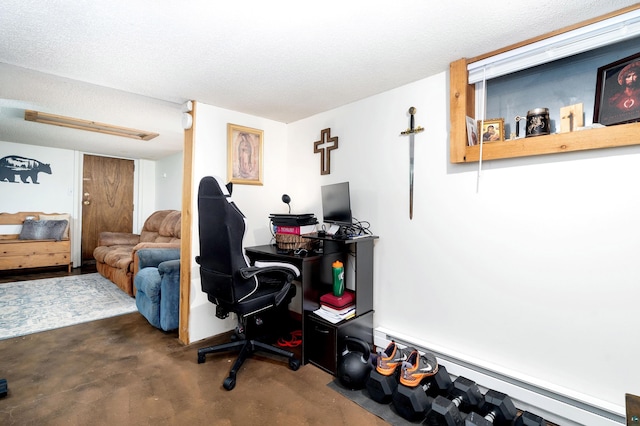 office area with finished concrete floors, a textured ceiling, and baseboard heating