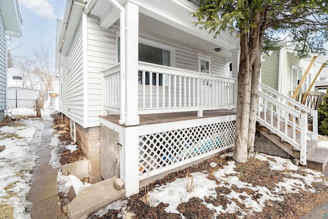 view of snowy exterior with a porch