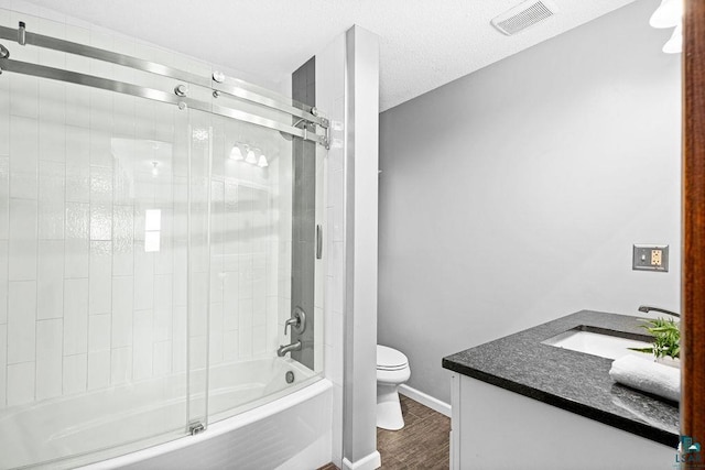 full bath with shower / bath combination with glass door, visible vents, toilet, vanity, and wood finished floors