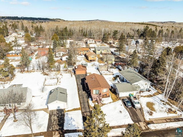 snowy aerial view with a residential view