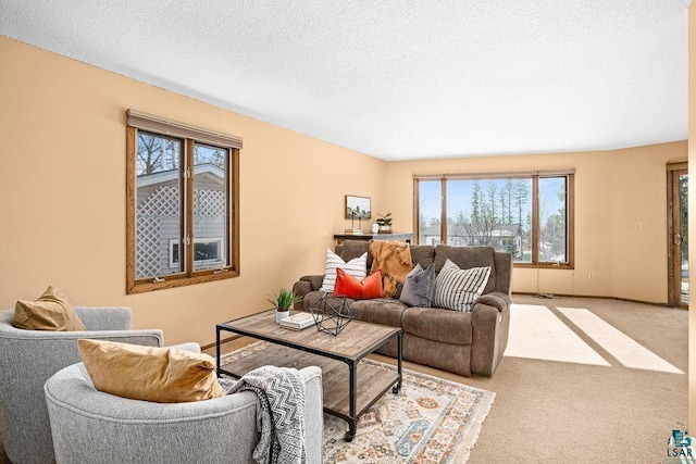 living room with light carpet, baseboards, and a textured ceiling