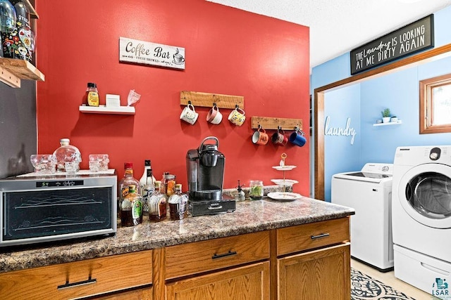 laundry area with laundry area, a bar, washing machine and dryer, and a toaster