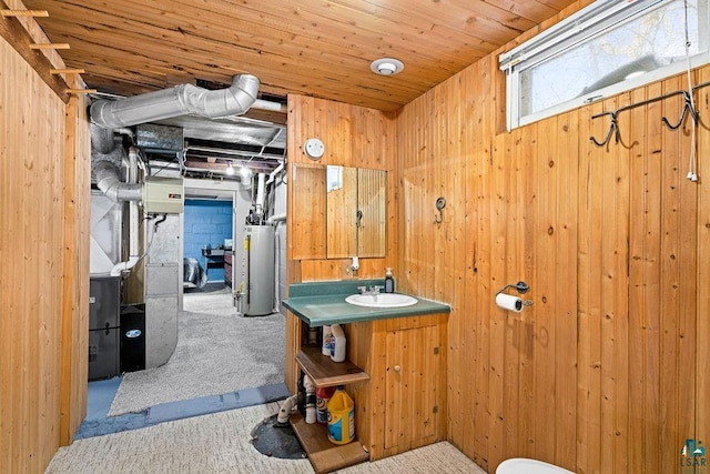 bathroom featuring wood walls and gas water heater