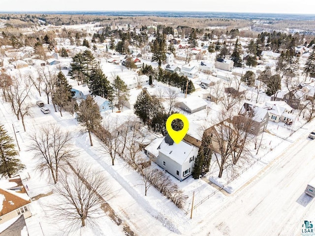 snowy aerial view with a residential view