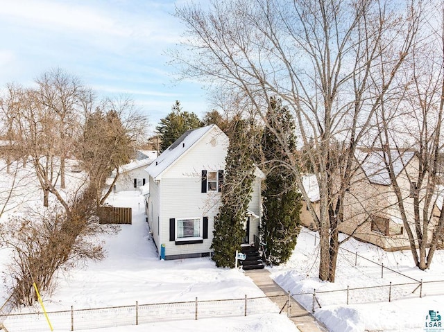 view of snowy exterior featuring fence private yard