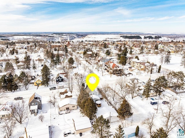 snowy aerial view featuring a residential view