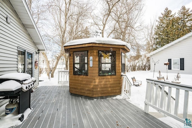 snow covered deck featuring area for grilling