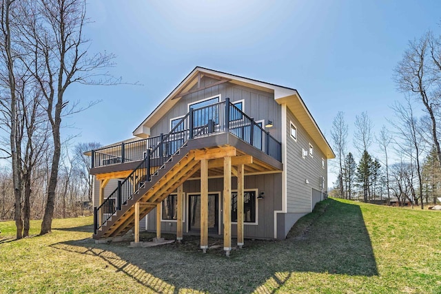 rear view of house featuring board and batten siding, stairway, a wooden deck, and a yard