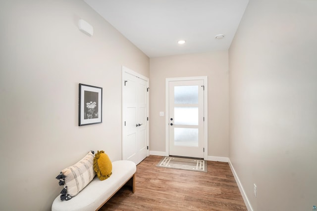 entryway featuring baseboards, wood finished floors, and recessed lighting