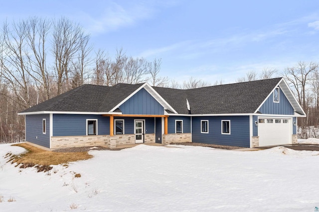 view of front of home featuring stone siding, board and batten siding, and roof with shingles