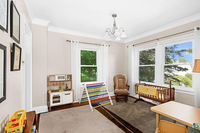 playroom featuring ornamental molding, a wealth of natural light, and wood finished floors