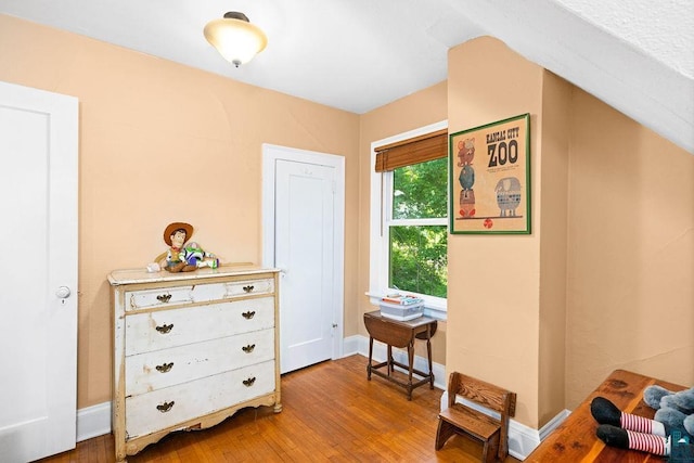 sitting room with wood finished floors and baseboards