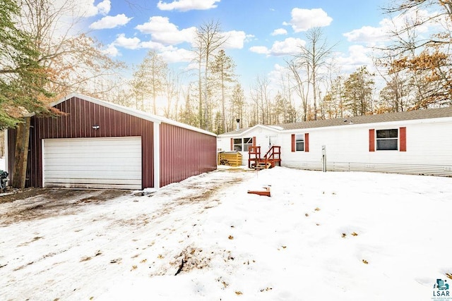 view of front of property with an outbuilding and a detached garage