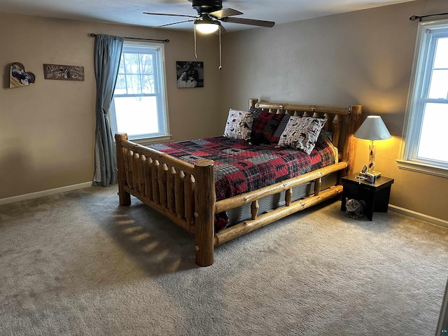 carpeted bedroom featuring ceiling fan and baseboards