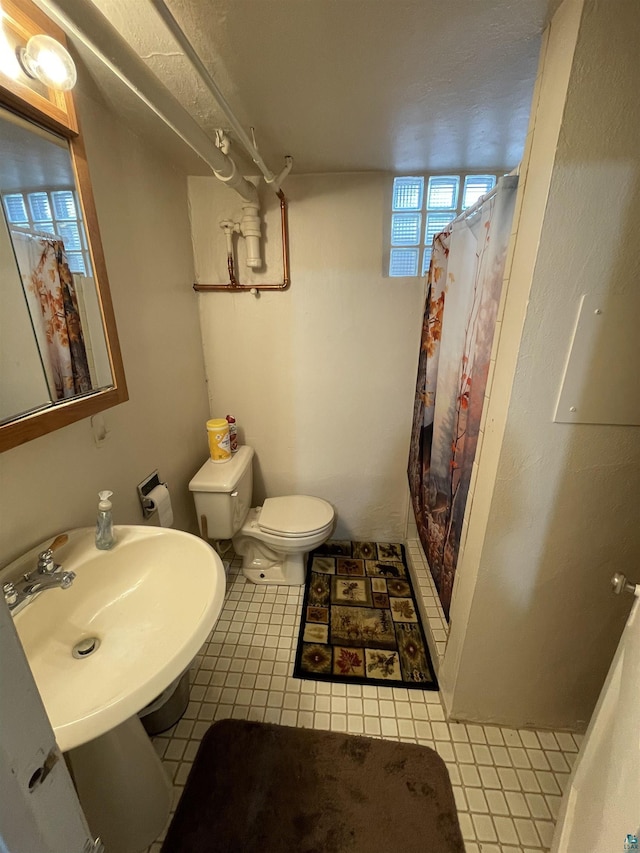 bathroom featuring toilet and a shower with shower curtain