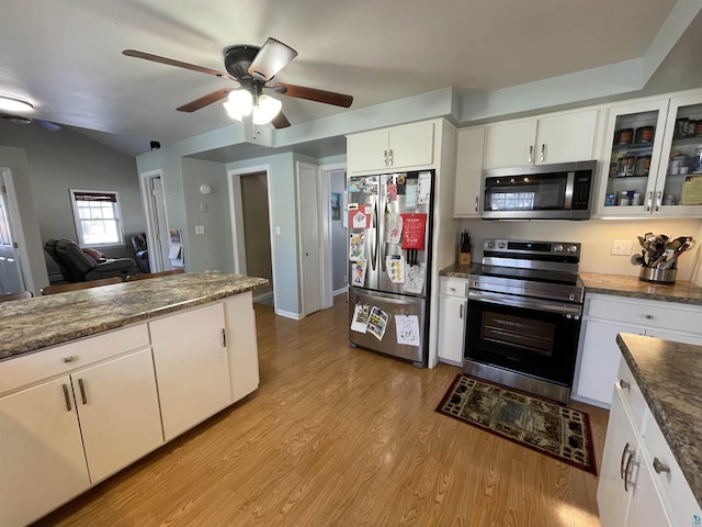 kitchen with light wood finished floors, appliances with stainless steel finishes, glass insert cabinets, a ceiling fan, and white cabinets