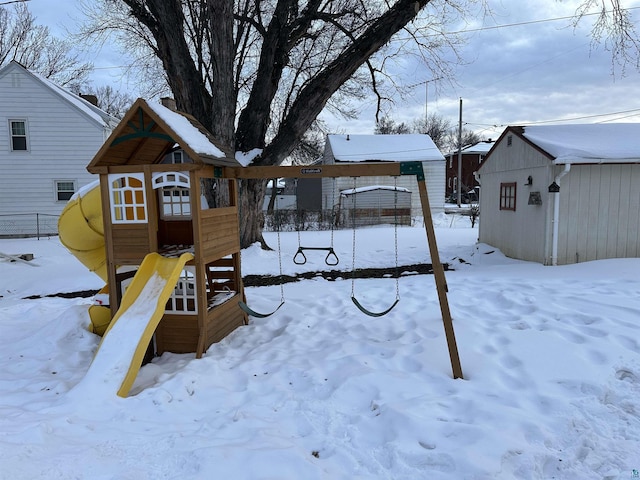 snow covered playground with a playground and an outdoor structure