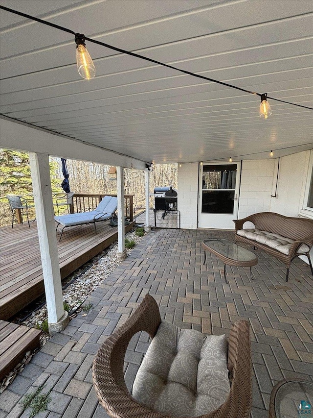 wooden terrace featuring a patio area