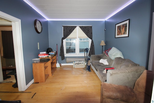 living area with baseboards and hardwood / wood-style floors