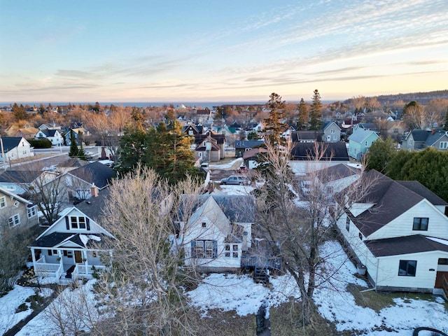 aerial view at dusk featuring a residential view