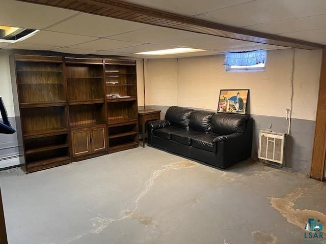 interior space with concrete flooring and a drop ceiling