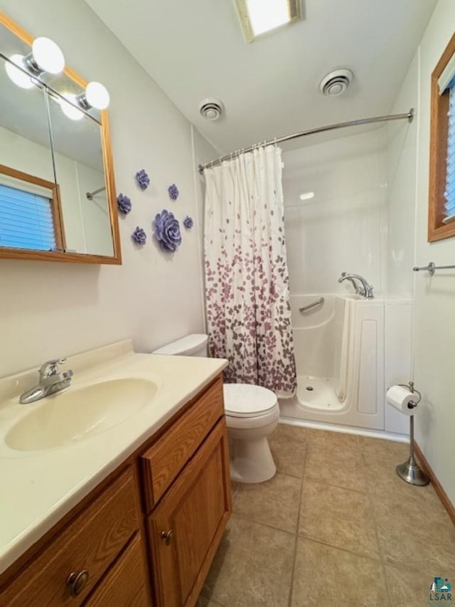 bathroom with shower / bath combo, visible vents, vanity, and toilet