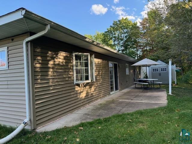 view of home's exterior featuring a patio and a lawn