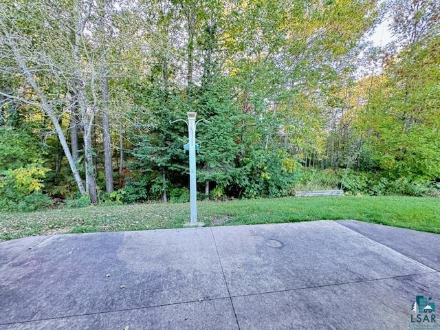 view of patio featuring a wooded view