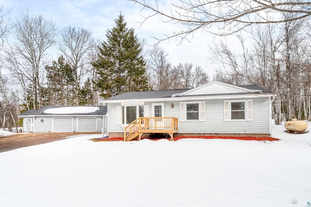 snow covered back of property with an outbuilding