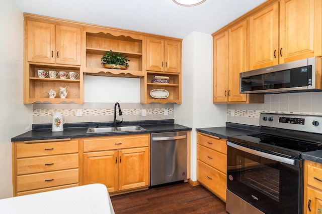 kitchen with dark countertops, appliances with stainless steel finishes, dark wood-type flooring, open shelves, and a sink