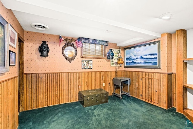 unfurnished office with carpet, a wainscoted wall, visible vents, wood walls, and wallpapered walls